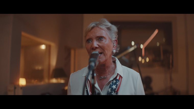 Nat J Holt singing into a studio microphone